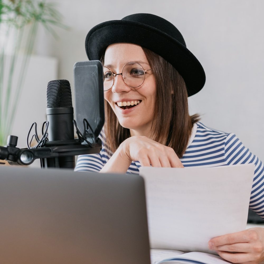 woman-with-microphone-and-headphones-in-recording-studio-recording-content-or-podcast.jpg